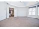 Large main bedroom featuring carpeting, tray ceiling, and view into another living space at 6450 Oak Valley Dr, Cumming, GA 30040