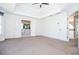 Large main bedroom featuring carpeting, tray ceiling, and view into bathroom with tub at 6450 Oak Valley Dr, Cumming, GA 30040