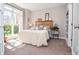 Bright bedroom with natural light, a cozy bed, and a bookcase at 6450 Oak Valley Dr, Cumming, GA 30040