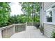 Inviting outdoor deck with wood railing, chairs, trees and natural light at 6450 Oak Valley Dr, Cumming, GA 30040