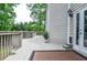 Relaxing outdoor deck with wood railing, showing house siding and trees at 6450 Oak Valley Dr, Cumming, GA 30040
