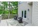 Inviting outdoor deck with wood railing, chairs, trees, rug and natural light at 6450 Oak Valley Dr, Cumming, GA 30040
