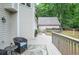 Inviting deck area with outdoor seating and a serene view of the lush backyard and detached garage at 6450 Oak Valley Dr, Cumming, GA 30040