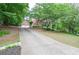 Two-story traditional home with attached garage, large yard, and driveway at 6450 Oak Valley Dr, Cumming, GA 30040