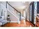 Open foyer with hardwood floors, staircase, and decorative iron front door at 6450 Oak Valley Dr, Cumming, GA 30040