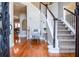 Elegant foyer featuring hardwood floors, staircase, and stylish decor at 6450 Oak Valley Dr, Cumming, GA 30040