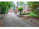 Brick home with three car garage and long driveway at 6450 Oak Valley Dr, Cumming, GA 30040