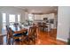 Open concept kitchen and dining area with stainless steel appliances, hardwood floors, and a large dining table at 6450 Oak Valley Dr, Cumming, GA 30040
