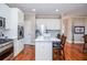 Modern kitchen with stainless appliances, an island, and hardwood floors throughout the area at 6450 Oak Valley Dr, Cumming, GA 30040