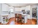 Bright kitchen boasting white cabinets, stainless steel appliances, and a cozy breakfast bar with seating at 6450 Oak Valley Dr, Cumming, GA 30040