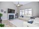 Spacious living room with a fireplace, large windows, and a comfortable white sectional sofa at 6450 Oak Valley Dr, Cumming, GA 30040
