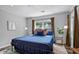 Comfortable bedroom featuring a cozy blue bed with natural light and stylish decor at 1140 Allgood Rd, Stone Mountain, GA 30083