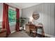 Bedroom with a work space, paneled walls, natural light and view to the outdoors at 1140 Allgood Rd, Stone Mountain, GA 30083