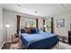 Cozy bedroom featuring hardwood floors, warm lighting, and comfortable furnishings, creating a relaxing retreat at 1140 Allgood Rd, Stone Mountain, GA 30083