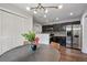 Eat-in kitchen area with modern lighting, stainless steel refrigerator, and access to the kitchen at 1140 Allgood Rd, Stone Mountain, GA 30083