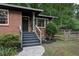 An inviting front entrance features stairs and sidewalk leading to a dark-colored front door at 1140 Allgood Rd, Stone Mountain, GA 30083