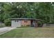 Charming single-story home with a brick facade, neutral siding, and a well-maintained lawn at 1140 Allgood Rd, Stone Mountain, GA 30083