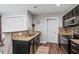 Well-equipped kitchen with granite countertops, stainless steel appliances, and ample storage at 1140 Allgood Rd, Stone Mountain, GA 30083