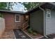 Rear exterior view of home featuring an exposed foundation and grey siding at 1140 Allgood Rd, Stone Mountain, GA 30083
