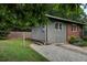 Side exterior view of home featuring gravel driveway and grey siding at 1140 Allgood Rd, Stone Mountain, GA 30083