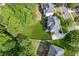 A beautiful suburban home sits on a well-maintained lot with lush, green grass and mature trees at 2572 Hillgrove Dr, Dacula, GA 30019