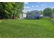 Expansive backyard with lush green lawn and rear view of home, perfect for outdoor activities at 2572 Hillgrove Dr, Dacula, GA 30019