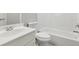 Bathroom featuring a subway tiled shower, a toilet, and a sink with a white countertop at 2572 Hillgrove Dr, Dacula, GA 30019