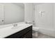 Bathroom featuring white subway tile, a black vanity, and modern fixtures at 2572 Hillgrove Dr, Dacula, GA 30019