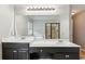 Bathroom with a double vanity and a large mirror overlooking the soaking tub and tiled shower at 2572 Hillgrove Dr, Dacula, GA 30019