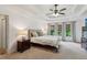 Bedroom with a tray ceiling, a ceiling fan, and multiple windows with bright natural light at 2572 Hillgrove Dr, Dacula, GA 30019