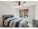 Bright bedroom featuring a ceiling fan, comfortable carpet, and a window with natural light at 2572 Hillgrove Dr, Dacula, GA 30019