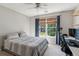 Cozy bedroom with a ceiling fan, plush carpet, and a window offering views of the outdoors at 2572 Hillgrove Dr, Dacula, GA 30019
