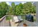 Outdoor deck with seating and a grill overlooking a beautiful yard at 2572 Hillgrove Dr, Dacula, GA 30019