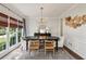 Elegant dining room with natural light, stylish chandelier, and decorative accents at 2572 Hillgrove Dr, Dacula, GA 30019