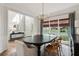 Dining room with wainscoting, modern light fixture, and large windows at 2572 Hillgrove Dr, Dacula, GA 30019