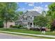 Two-story home with gray siding, a lush front yard, and a side-entry garage at 2572 Hillgrove Dr, Dacula, GA 30019