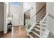 Bright foyer with hardwood floors, a staircase, and a high ceiling at 2572 Hillgrove Dr, Dacula, GA 30019