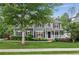 Charming gray two-story home with a well-manicured lawn and a covered front porch at 2572 Hillgrove Dr, Dacula, GA 30019