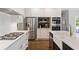Spacious kitchen featuring a gas range, stainless steel appliances, and a center island with a farmhouse sink at 2572 Hillgrove Dr, Dacula, GA 30019
