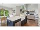 Open concept kitchen with blue island and stainless steel appliances connected to living area at 2572 Hillgrove Dr, Dacula, GA 30019