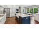 Spacious kitchen featuring a gas range, stainless steel appliances, and a center island with a farmhouse sink at 2572 Hillgrove Dr, Dacula, GA 30019