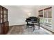 Home office with piano, dark wood floors, and a large window at 2572 Hillgrove Dr, Dacula, GA 30019