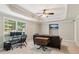 Comfortable living room featuring tray ceilings, a workstation, and large windows offering natural light at 2572 Hillgrove Dr, Dacula, GA 30019