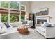 Cozy living room featuring a fireplace, large windows, and comfortable seating at 2572 Hillgrove Dr, Dacula, GA 30019