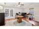 Well-lit office with french doors, hardwood floors, multiple desks, and tray ceilings at 2572 Hillgrove Dr, Dacula, GA 30019