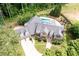 Stone home with a pool and spa in a wooded lot, featuring mature trees and landscaping at 355 Clark Creek Pass, Acworth, GA 30102