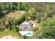 Estate aerial view featuring a luxurious home, swimming pool, and sprawling grounds surrounded by lush trees at 355 Clark Creek Pass, Acworth, GA 30102