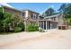 Exterior view of the home's lush backyard with an enclosed sunroom and brick paved patio and lawn at 355 Clark Creek Pass, Acworth, GA 30102