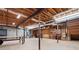 Unfinished basement with exposed wood ceiling, support beams, and shelves offers ample storage and utility space at 355 Clark Creek Pass, Acworth, GA 30102
