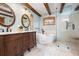 Luxurious bathroom with a standalone tub, glass shower, wooden accents, and dual vanities at 355 Clark Creek Pass, Acworth, GA 30102